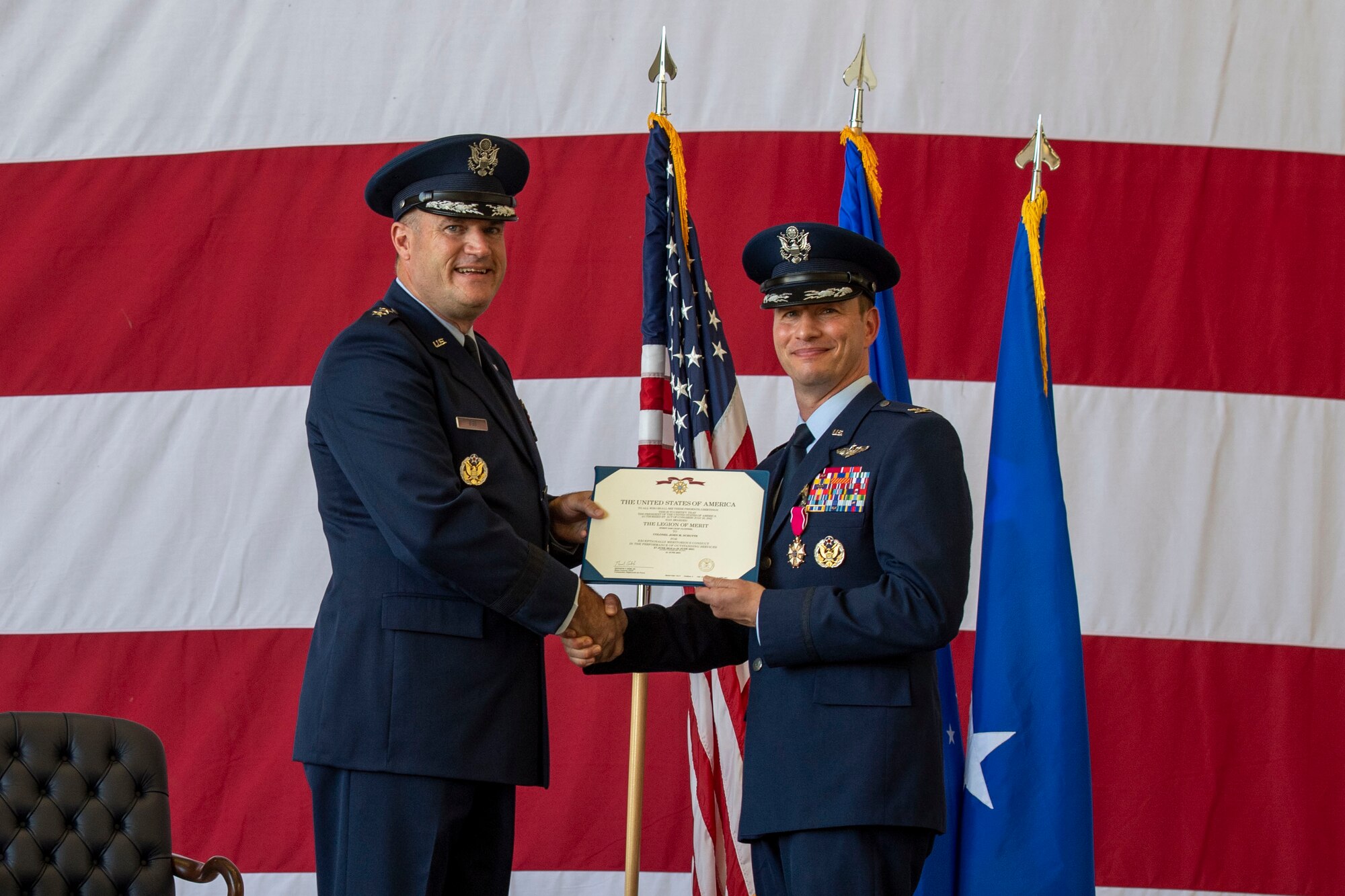 An Airman is presented the Legion of Merit medal at a change of command ceremony.