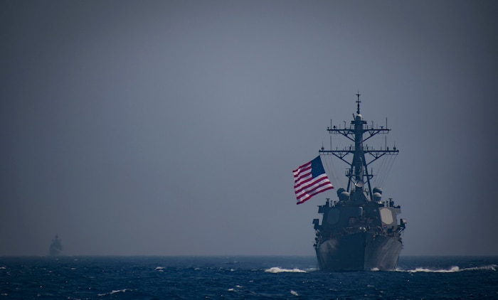 The Arleigh Burke-class guided-missile destroyers USS Ross (DDG 71) and USS Winston S. Churchill (DDG 81) transit the Mediterranean Sea as a helicopter assigned to the French horizon-class frigate Chevalier Paul (D 621) flies overhead Sept. 3, 2018.