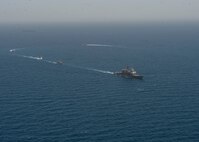 210608-N-RG587-1336 ARABIAN GULF (June 8, 2021) Guided-missile cruiser USS Vella Gulf (CG 72), patrol coastal ship USS Thunderbolt (PC 12), Coast Guard patrol boat USCGC Monomoy (WPB 1326), and Kuwait Navy patrol boats KNS Istiqlal (P5702) and KNS Al-Garoh (P3725), operate in formation during Eager Defender 21 in the Arabian Gulf, June 8. Eager Defender 21 is the capstone in a series of bilateral exercises between Kuwait and U.S. naval forces, focused on enhancing mutual capabilities and interoperability in maritime security operations. (U.S. Navy photo by Mass Communication Specialist 2nd Class Dean M. Cates)