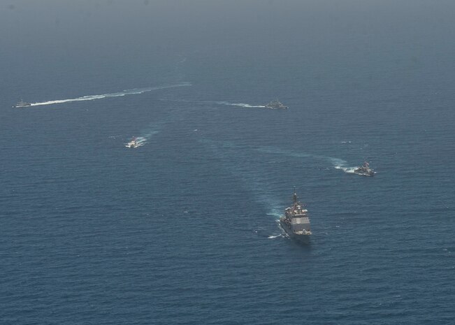 210608-N-RG587-1423 ARABIAN GULF (June 8, 2021) Guided-missile cruiser USS Vella Gulf (CG 72), patrol coastal ship USS Thunderbolt (PC 12), Coast Guard patrol boat USCGC Monomoy (WPB 1326), and Kuwait Navy patrol boats KNS Istiqlal (P5702) and KNS Al-Garoh (P3725), operate in formation during Eager Defender 21 in the Arabian Gulf, June 8. Eager Defender 21 is the capstone in a series of bilateral exercises between Kuwait and U.S. naval forces, focused on enhancing mutual capabilities and interoperability in maritime security operations. (U.S. Navy photo by Mass Communication Specialist 2nd Class Dean M. Cates)