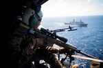 210623-M-TS451-2483 PHILIPPINE SEA - A U.S. Marine with Force Reconnaissance Platoon, 31st Marine Expeditionary Unit (MEU), observes the Philippine Sea while in route to the USS Germantown (LSD 42) to conduct a Maritime Interdiction Operation (MIO) training exercise June 24, 2021. The MIO consisted of Force Reconnaissance Marines fast roping on to the USS Germantown and executing a search and seizure scenario with support from the Battalion Landing Team 3/5 as the security element. The 31st MEU is operating aboard ships of the America Amphibious Ready Group in the 7th fleet area of operation to enhance interoperability with allies and partners and serve as a ready response force to defend peace and stability in the Indo-Pacific region. (U.S. Marine Corps photo by Cpl. Karis Mattingly)