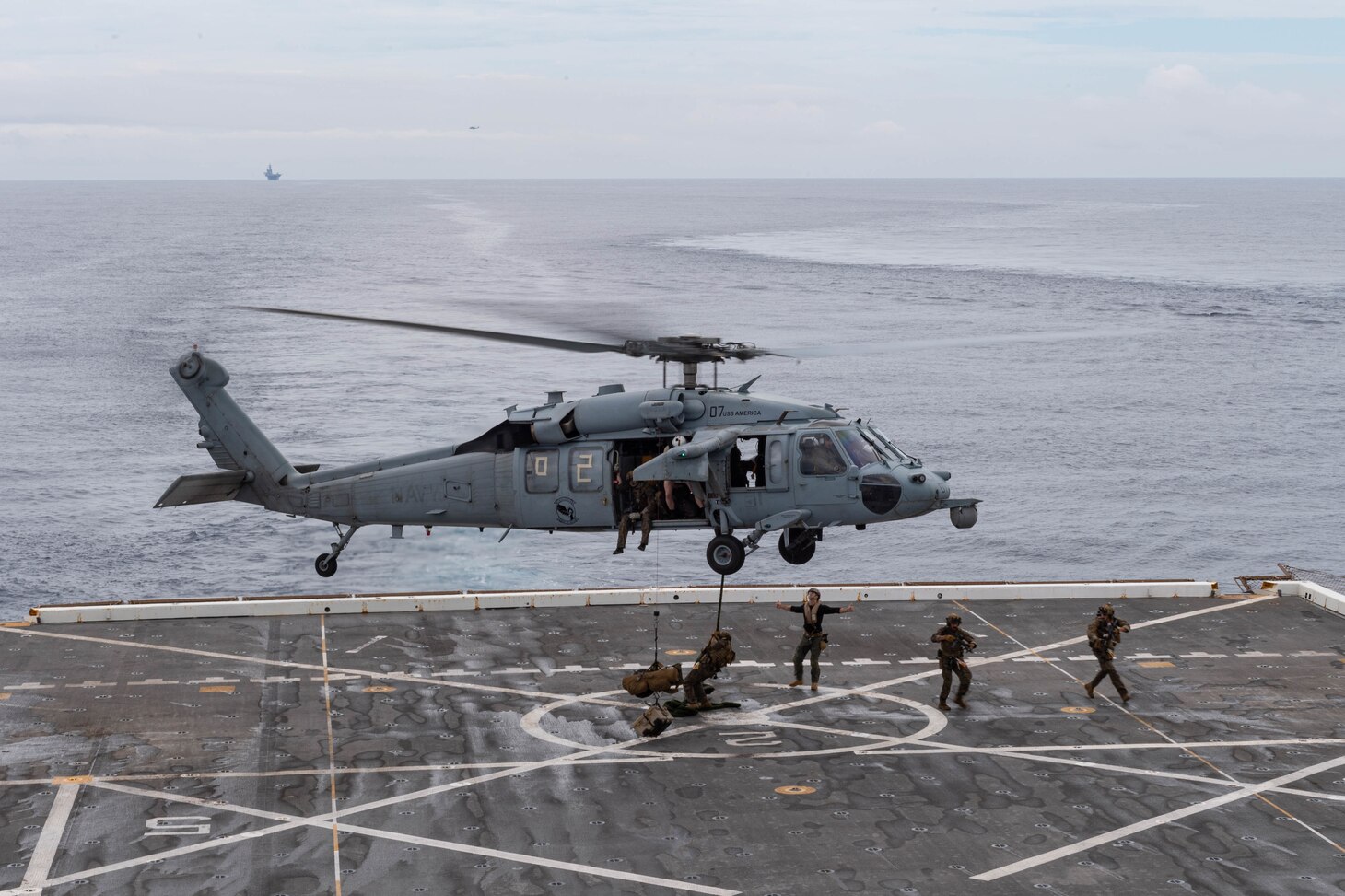 210614-N-XB010-1015 EAST CHINA SEA (June 14, 2021) Marines attached to the 31st Marine Expeditionary Unit (MEU) fast rope from a Marine Corps MH-60S: Sea Hawk from the 31st MEU on USS New Orleans’s (LPD 18) flight deck during a Maritime Raid Force training evolution with USS Germantown (LSD 42). New Orleans, part of the America Amphibious Ready Group, along with the 31st Marine Expeditionary Unit, is operating in the U.S. 7th Fleet area of responsibility to enhance interoperability with allies and partners and serve as a ready response force to defend peace and stability in the Indo-Pacific region. (U.S. Navy photo by Mass Communication Specialist 2nd Class Desmond Parks)