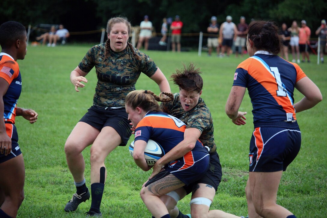 Marine Corps LCpl Kerra Wieberg of Marine Corps Base Camp Pendleton, Calif. collides with Coast Guard Lt. J.G. Sheila Bertrand of Washington, D.C. during the opening match of the 2021 Armed Forces Rugby Championship held in conjunction with the 2021 Cape Fear Rugby Sevens Tournament, held from 24-28 June.  Service members from the Army, Marine Corps, Navy, Air Force (with Space Force personnel) and Coast Guard battle it out for gold.  (Department of Defense Photo, Released)