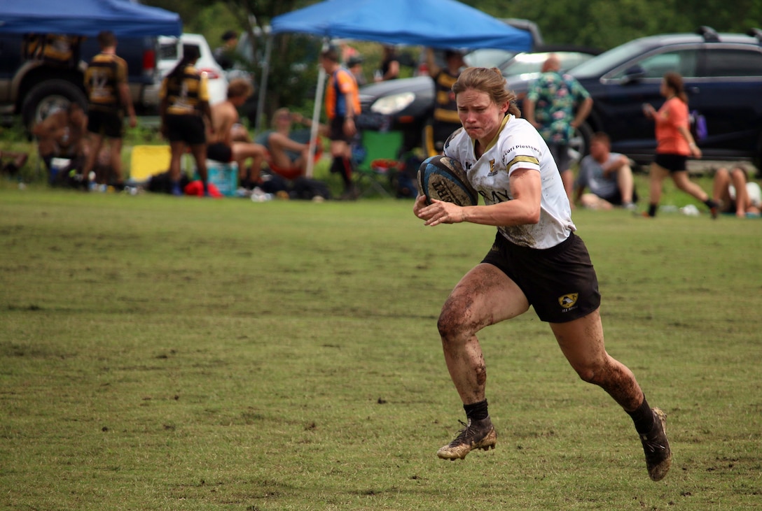 Army 2nd lt. Samantha Sullivan of Fort Carson, Colo. drives to the try zone against the Marine Corps during the 2021 Armed Forces Rugby Championship held in conjunction with the 2021 Cape Fear Rugby Sevens Tournament, held from 24-28 June.  Service members from the Army, Marine Corps, Navy, Air Force (with Space Force personnel) and Coast Guard battle it out for gold.  (Department of Defense Photo, Released)