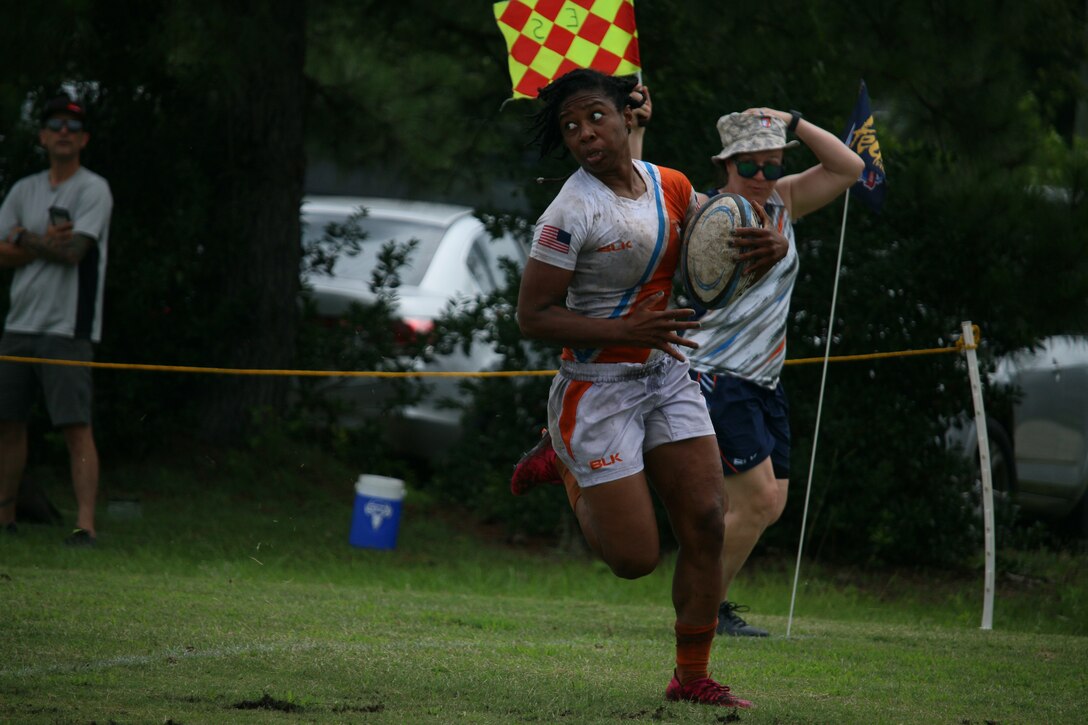 Coast Guard Seaman Ra'Shaun Combs from Yorktown, Va. scores a try against Navy in the 2021 Armed Forces Rugby Championship held in conjunction with the 2021 Cape Fear Rugby Sevens Tournament, held from 24-28 June.  Service members from the Army, Marine Corps, Navy, Air Force (with Space Force personnel) and Coast Guard battle it out for gold.  (Department of Defense Photo, Released)
