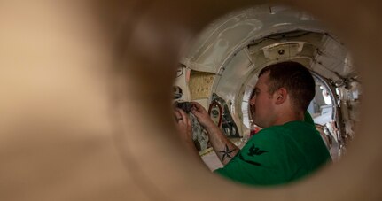 Aviation Machinist Mate 3rd Class Jeremy Southerland, from Spring, Texas, verifies the seal of anti-seize on the motor mounts of an F/A-18E Super Hornet, attached to the "Blue Blasters" of Strike Fighter Squadron (VFA) 34, in the hangar bay of the Nimitz-class aircraft carrier USS Harry S. Truman (CVN 75) during Group Sail.