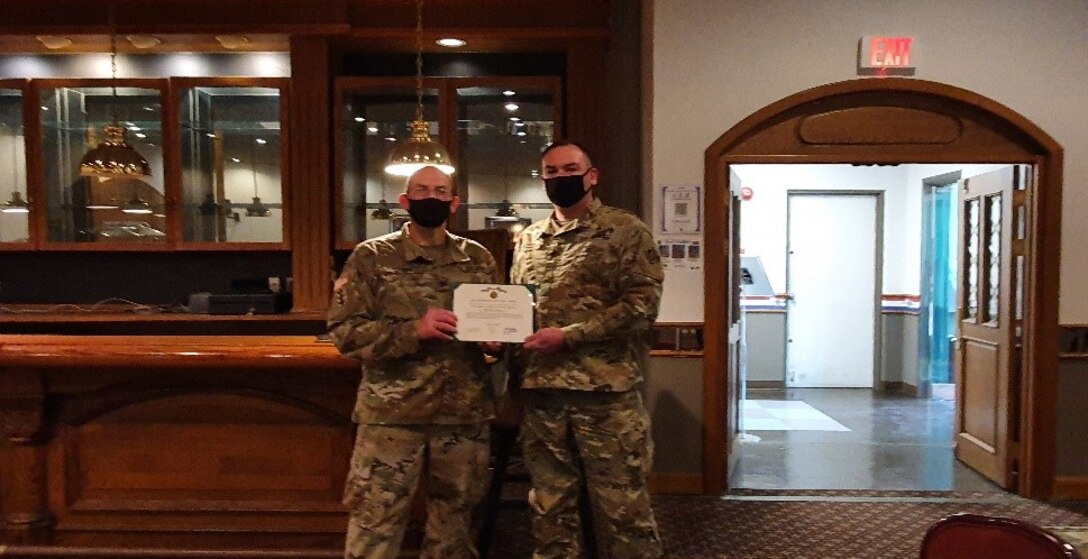 Far East District Commander, COL Christopher Crary, presents SSG Timothy Sepkoski, Southern Resident Office Quality Assurance Rep, with an end-of-service award. Upon separation from the Army, Sepkoski will join SRO as a Civilian.