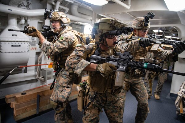 210614-N-XB010-1020 EAST CHINA SEA (June 14, 2021) Marines attached to the 31st Marine Expeditionary Unit (MEU) search USS New Orleans (LPD 18) during a Maritime Raid Force training evolution with USS Germantown (LSD 42). New Orleans, part of the America Amphibious Ready Group, along with the 31st Marine Expeditionary Unit, is operating in the U.S. 7th Fleet area of responsibility to enhance interoperability with allies and partners and serve as a ready response force to defend peace and stability in the Indo-Pacific region. (U.S. Navy photo by Mass Communication Specialist 2nd Class Desmond Parks)