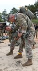 U.S. Army Reserve Chief Warrant Officer 5 (CW5) Michael A. Rich, command chief warrant officer for the U.S. Army Civil Affairs and Psychological Operations Command (Airborne), dons his parachute with the assistance of Lt. Col. Mark S. Flitton (left), deputy G3 operations for USACAPOC(A), in preparation for nontactical airborne operations, June 5, 2021, at Saint Mere Eglise drop zone, Fort Bragg, N.C. USACAPOC(A) jumpmasters worked with Capt. Ignacio Rios, a Chilean jumpmaster assigned to the 1st Special Warfare Training Group(A), U.S. Army John F. Kennedy Special Warfare Center and School (USAJFKSWCS). Paratroopers jumping during the airborne operations were eligible to earn foreign wings.