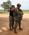 U.S. Army Reserve Master Sgt. Matthew G. Meyers, G3 air operations noncommissioned officer in charge and jumpmaster for the U.S. Army Civil Affairs and Psychological Operations Command (Airborne), conducts Jumpmaster Personnel Inspection (JMPI) for Maj. Frank J. Trinidad, deputy G6 for USACAPOC(A), in preparation for nontactical airborne operations, June 5, 2021, at Saint Mere Eglise drop zone, Fort Bragg, N.C. USACAPOC(A) jumpmasters worked with Capt. Ignacio Rios, a Chilean jumpmaster assigned to the 1st Special Warfare Training Group(A), U.S. Army John F. Kennedy Special Warfare Center and School (USAJFKSWCS). Paratroopers jumping during the airborne operations were eligible to earn foreign wings.