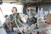 U.S. Army Reserve Lt. Col. Stephen M. Cowne, Jr., G33 and jumpmaster for the U.S. Army Civil Affairs and Psychological Operations Command (Airborne), watches as Capt. Ignacio Rios, a Chilean jumpmaster assigned to the 1st Special Warfare Training Group(A), U.S. Army John F. Kennedy Special Warfare Center and School (USAJFKSWCS) signal in preparation for nontactical airborne operations, June 5, 2021, at Saint Mere Eglise drop zone, Fort Bragg, N.C. Paratroopers jumping during the airborne operations were eligible to earn foreign wings.
