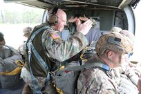 U.S. Army Reserve Lt. Col. Stephen M. Cowne, Jr., G33 and jumpmaster for the U.S. Army Civil Affairs and Psychological Operations Command (Airborne), and Capt. Ignacio Rios, a Chilean jumpmaster assigned to the 1st Special Warfare Training Group(A), U.S. Army John F. Kennedy Special Warfare Center and School (USAJFKSWCS) signal in preparation for nontactical airborne operations, June 5, 2021, at Saint Mere Eglise drop zone, Fort Bragg, N.C. Paratroopers jumping during the airborne operations were eligible to earn foreign wings.