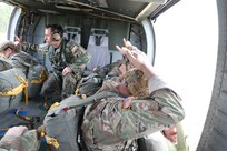 U.S. Army Reserve paratroopers prepare for nontactical airborne operations, June 5, 2021, at Saint Mere Eglise drop zone, Fort Bragg, N.C. USACAPOC(A) jumpmasters worked with Capt. Ignacio Rios, a Chilean jumpmaster assigned to the 1st Special Warfare Training Group(A), U.S. Army John F. Kennedy Special Warfare Center and School (USAJFKSWCS). Paratroopers jumping during the airborne operations were eligible to earn foreign wings.