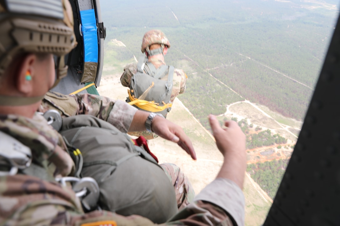 U.S. Army Reserve paratroopers with the U.S. Army Civil Affairs and Psychological Operations Command (Airborne) perform nontactical airborne operations at Saint Mere Eglise drop zone, Fort Bragg, N.C., June 5, 2021. USACAPOC(A) jumpmasters worked with Capt. Ignacio Rios, a Chilean jumpmaster assigned to the 1st Special Warfare Training Group(A), U.S. Army John F. Kennedy Special Warfare Center and School (USAJFKSWCS). Paratroopers jumping during the airborne operations were eligible to earn foreign wings.