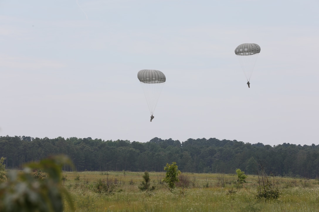 U.S. Army Reserve paratroopers with the U.S. Army Civil Affairs and Psychological Operations Command (Airborne) navigate to a landing during nontactical airborne operations at Saint Mere Eglise drop zone, Fort Bragg, N.C., June 5, 2021. USACAPOC(A) jumpmasters worked with Capt. Ignacio Rios, a Chilean jumpmaster assigned to the 1st Special Warfare Training Group(A), U.S. Army John F. Kennedy Special Warfare Center and School (USAJFKSWCS). Paratroopers jumping during the airborne operations were eligible to earn foreign wings
