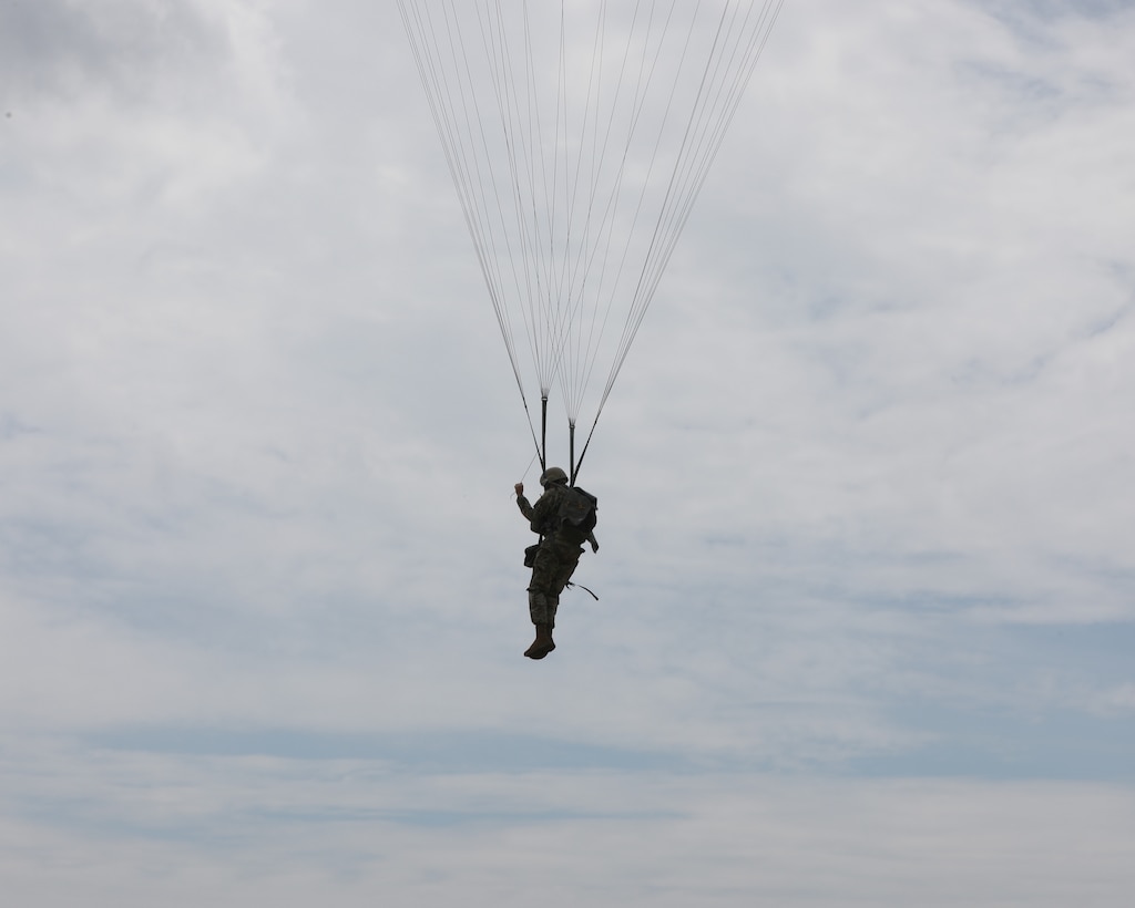 A U.S. Army Reserve paratrooper with the U.S. Army Civil Affairs and Psychological Operations Command (Airborne) navigates to a landing during nontactical airborne operations at Saint Mere Eglise drop zone, Fort Bragg, N.C., June 5, 2021. USACAPOC(A) jumpmasters worked with Capt. Ignacio Rios, a Chilean jumpmaster assigned to the 1st Special Warfare Training Group(A), U.S. Army John F. Kennedy Special Warfare Center and School (USAJFKSWCS). Paratroopers jumping during the airborne operations were eligible to earn foreign wings.