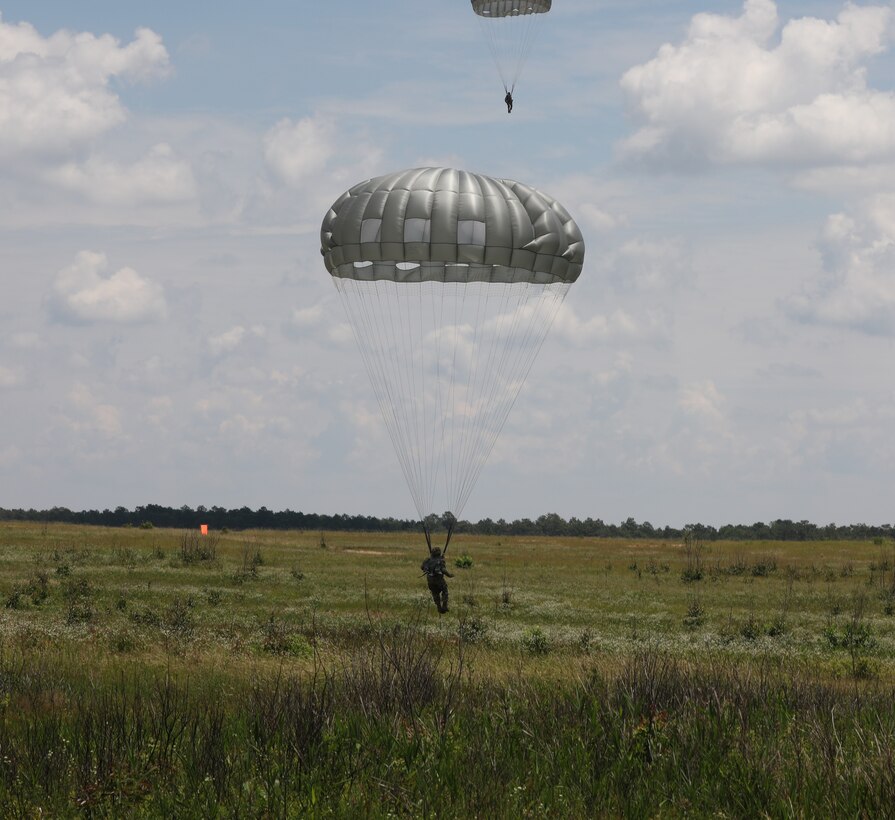 A U.S. Army Reserve paratrooper with the U.S. Army Civil Affairs and Psychological Operations Command (Airborne) executes to a landing during nontactical airborne operations from a UH-60 Black Hawk helicopter at Saint Mere Eglise drop zone, Fort Bragg, N.C., June 5, 2021. USACAPOC(A) jumpmasters worked with Capt. Ignacio Rios, a Chilean jumpmaster assigned to the 1st Special Warfare Training Group(A), U.S. Army John F. Kennedy Special Warfare Center and School (USAJFKSWCS). Paratroopers jumping during the airborne operations were eligible to earn foreign wings.