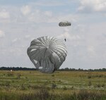 A U.S. Army Reserve paratrooper with the U.S. Army Civil Affairs and Psychological Operations Command (Airborne) executes a landing during nontactical airborne operations from a UH-60 Black Hawk helicopter at Saint Mere Eglise drop zone, Fort Bragg, N.C., June 5, 2021. USACAPOC(A) jumpmasters worked with Capt. Ignacio Rios, a Chilean jumpmaster assigned to the 1st Special Warfare Training Group(A), U.S. Army John F. Kennedy Special Warfare Center and School (USAJFKSWCS). Paratroopers jumping during the airborne operations were eligible to earn foreign wings.