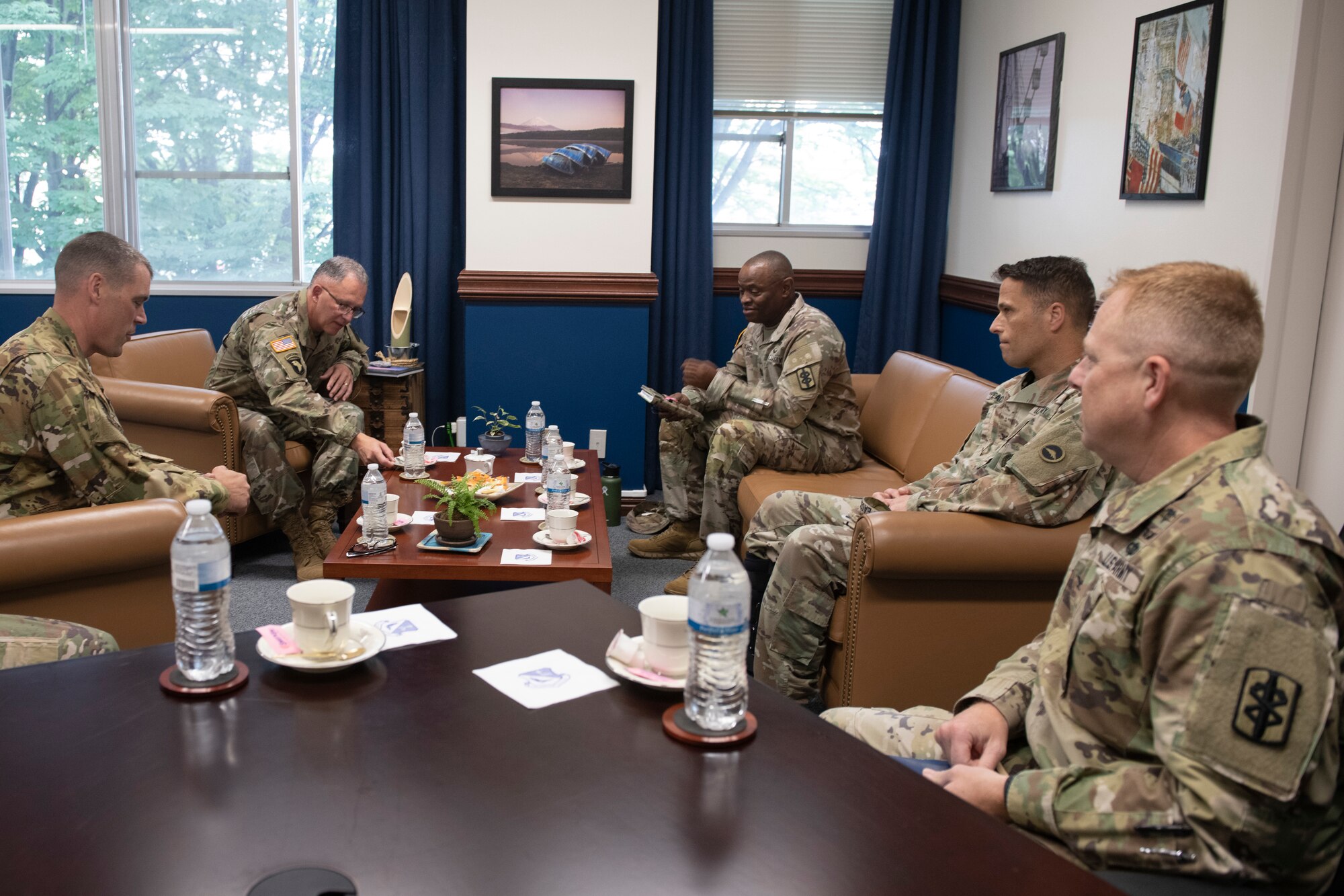 Maj. Gen. Michael Place, 18th Medical Command (Deployment Support) commanding general, left center, and his staff meet with Col. Andrew Campbell, 374th Airlift Wing Commander, left, at Yokota Air Base, Japan, June 24, 2021. This meeting gave Place and Campbell a chance to talk about how the 374th AW can support the deployment of medical equipment. (U.S. Air Force photo by Staff Sgt. Joshua Edwards)