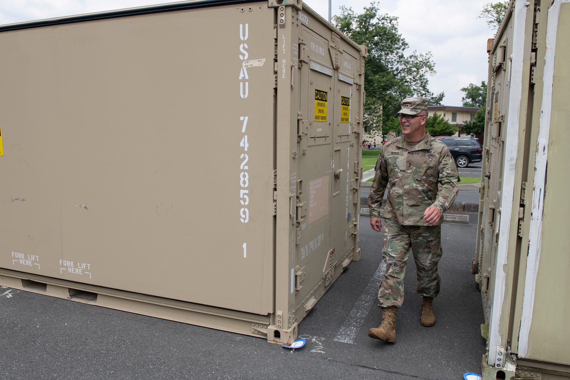 Maj. Gen. Michael Place, 18th Medical Command (Deployment Support) commanding general, inspects cargo containers at Yokota Air Base, Japan, June 24, 2021. The cargo containers were at Yokota as part of a forward deploying medical exercise. (U.S. Air Force photo by Staff Sgt. Joshua Edwards)