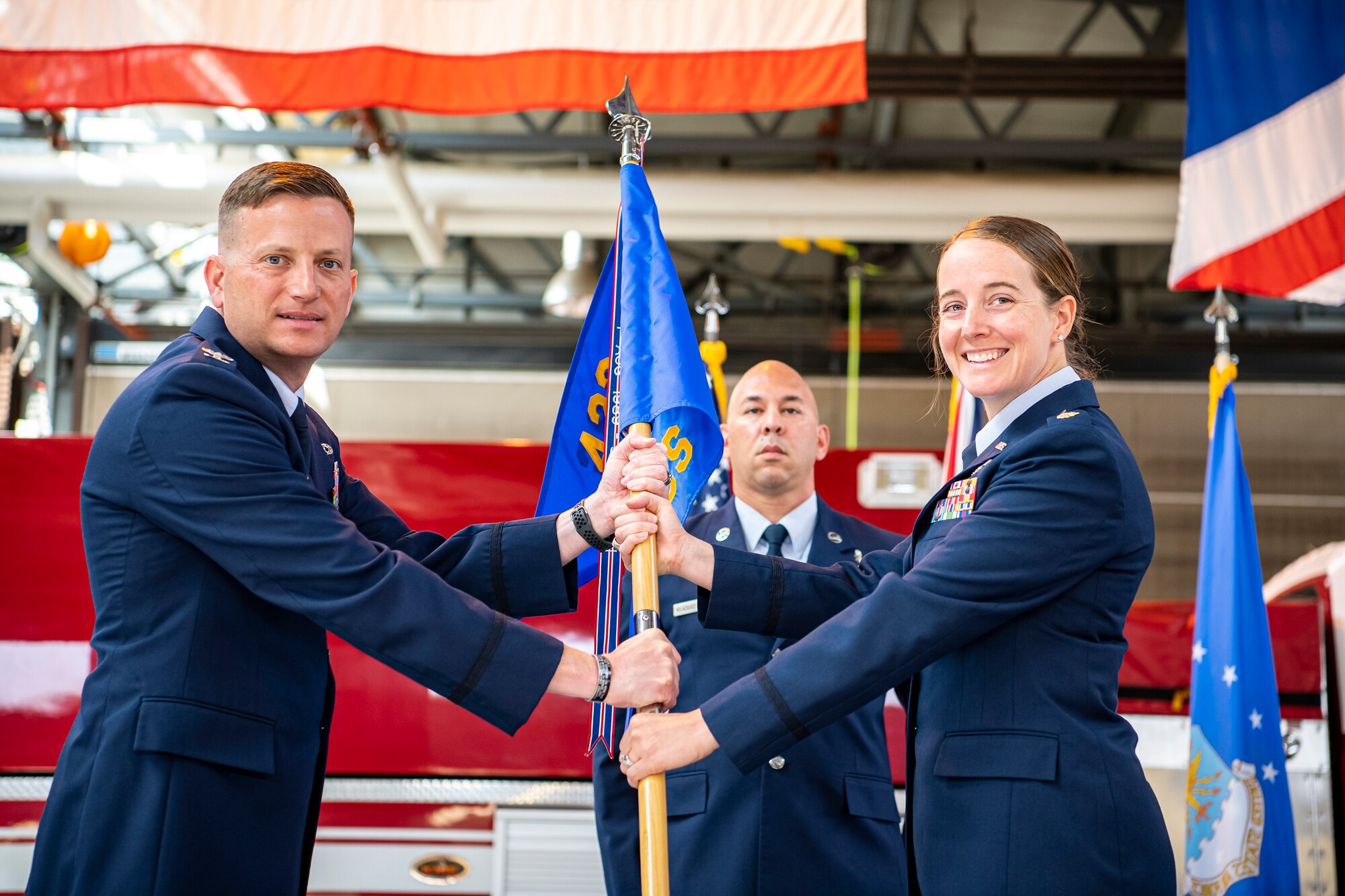 U.S. Air Force Col. Richard Martin, left, 423rd Air Base Group commander, presents the 423rd Communications Squadron guidon to Maj. Erica Balfour, 423rd CS incoming commander, during a change of command ceremony at RAF Alconbury, England, June 25, 2021. Prior to assuming command of the 423rd CS Balfour was a student at the Air Command and Staff College, Maxwell Air Force Base, Alabama. (U.S. Air Force photo by Senior Airman Eugene Oliver)