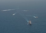 ARABIAN GULF (June 8, 2021) Guided-missile cruiser USS Vella Gulf (CG 72), patrol coastal ship USS Thunderbolt (PC 12), Coast Guard patrol boat USCGC Monomoy (WPB 1326), and Kuwait Navy patrol boats KNS Istiqlal (P5702) and KNS Al-Garoh (P3725), operate in formation during Eager Defender 21 in the Arabian Gulf, June 8. Eager Defender 21 is the capstone in a series of bilateral exercises between Kuwait and U.S. naval forces, focused on enhancing mutual capabilities and interoperability in maritime security operations. (U.S. Navy photo by Mass Communication Specialist 2nd Class Dean M. Cates)