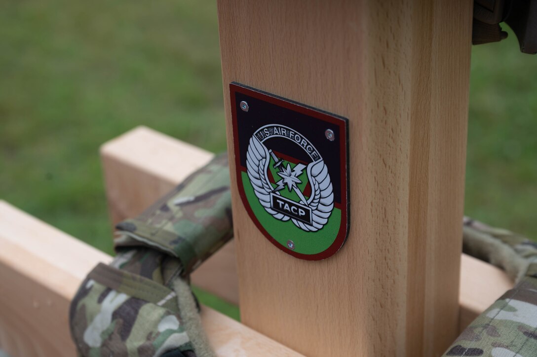 A TACP emblem rests on a stanchion.