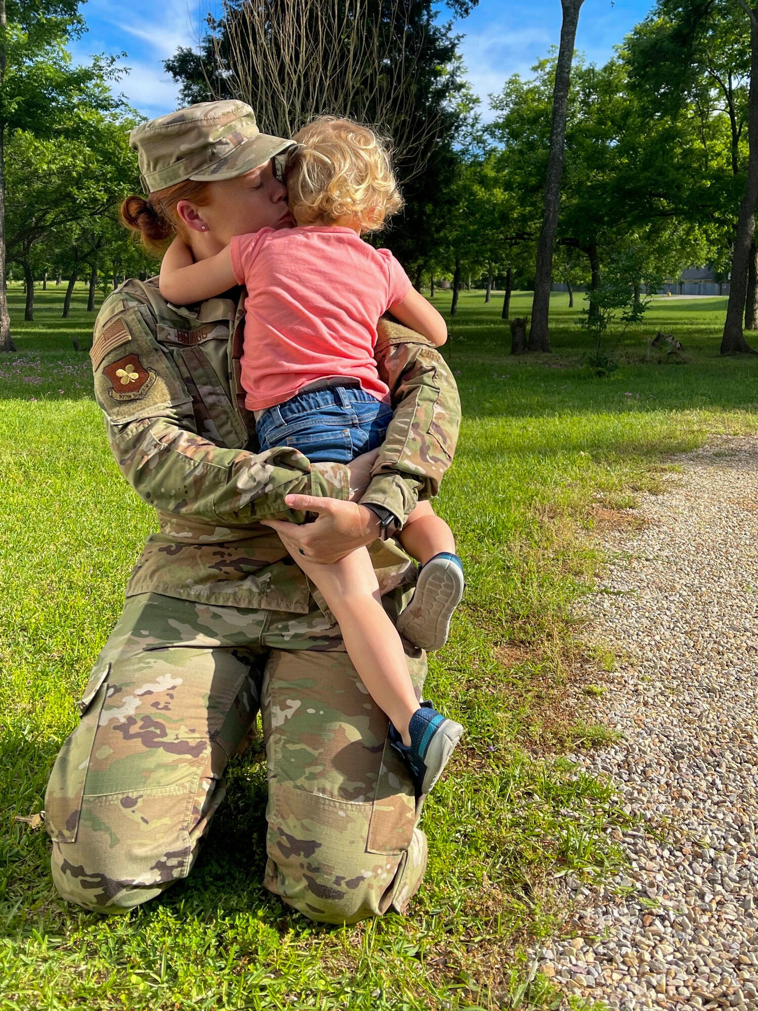 Airman hugs her daughter.