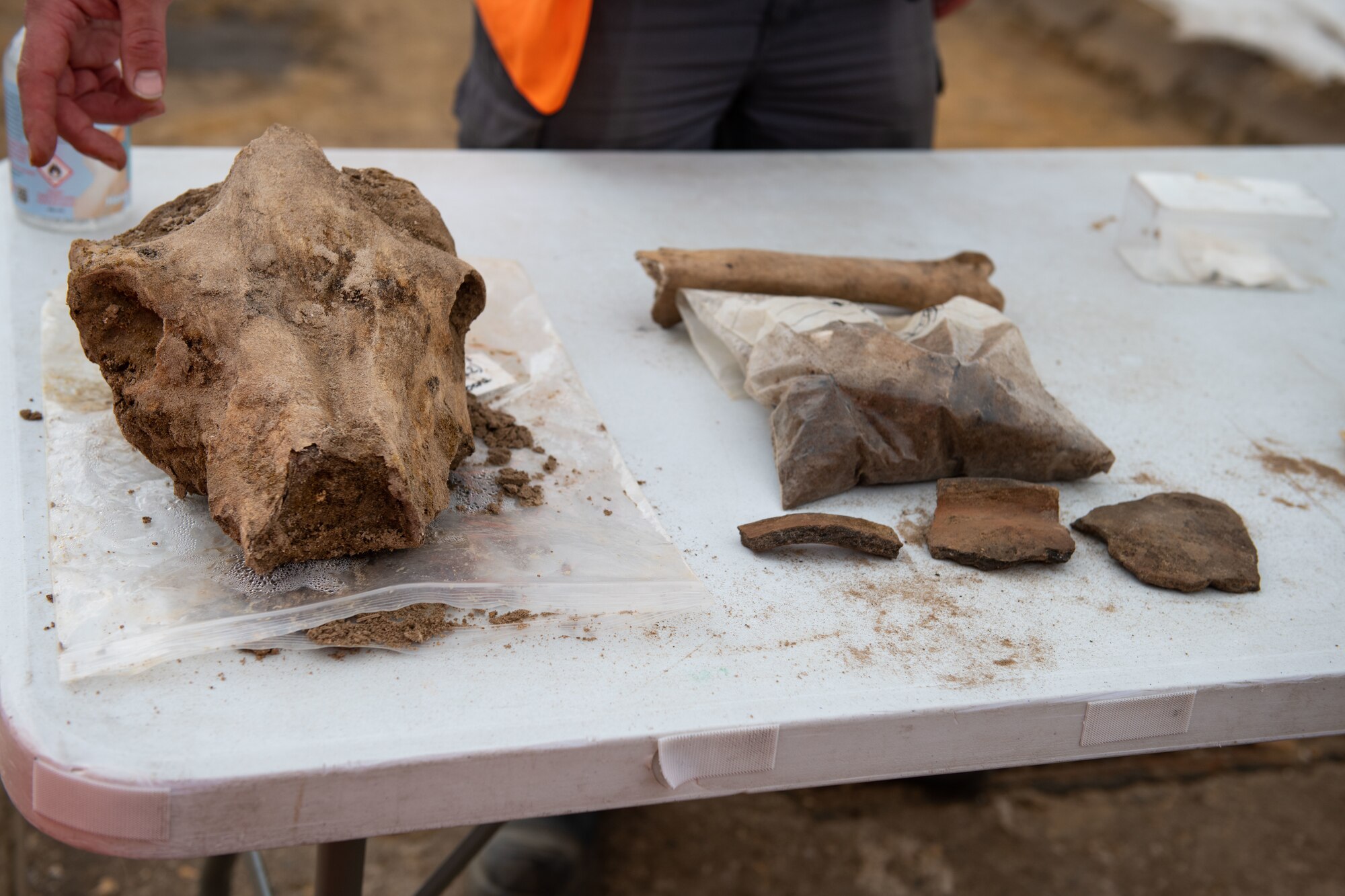 An Archaeologist with Cotswold Archaeology displays remains that were found during an archaeological dig on Royal Air Force Lakenheath, England, June 10, 2021. Liberty Wing Members recently halted construction on base when finding indications of ancient graves and artifacts dating back to 100 B.C shortly after excavation began. (U.S. Air Force photo by Airman 1st Class Cedrique Oldaker)