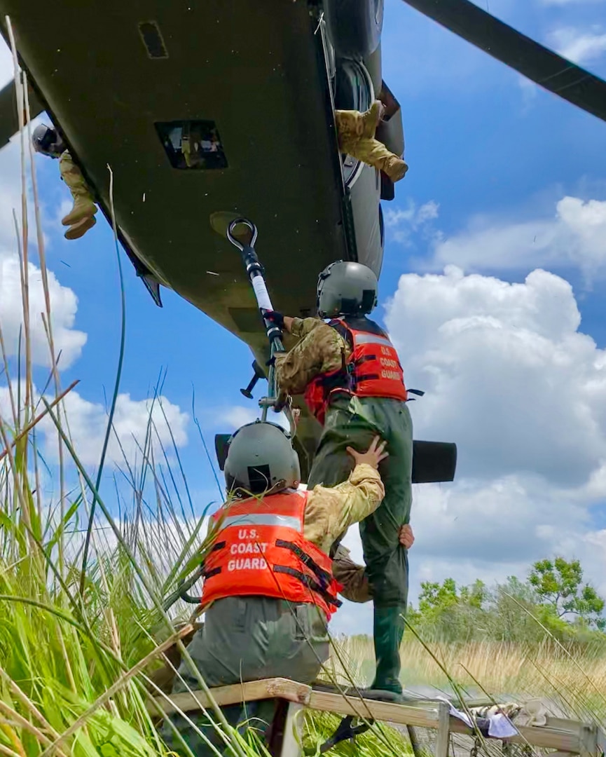 Members with the U.S. Army and U.S. Army National Guard connect a fallen Rear Range Light to a UH-60 Black Hawk helicopter near Beaumont, Texas, May 27, 2021. The tower had become a navigational hazard after being knocked down during Hurricane Laura. (U.S. Coast Guard photo by Petty Officer 3rd Class Paige Hause)