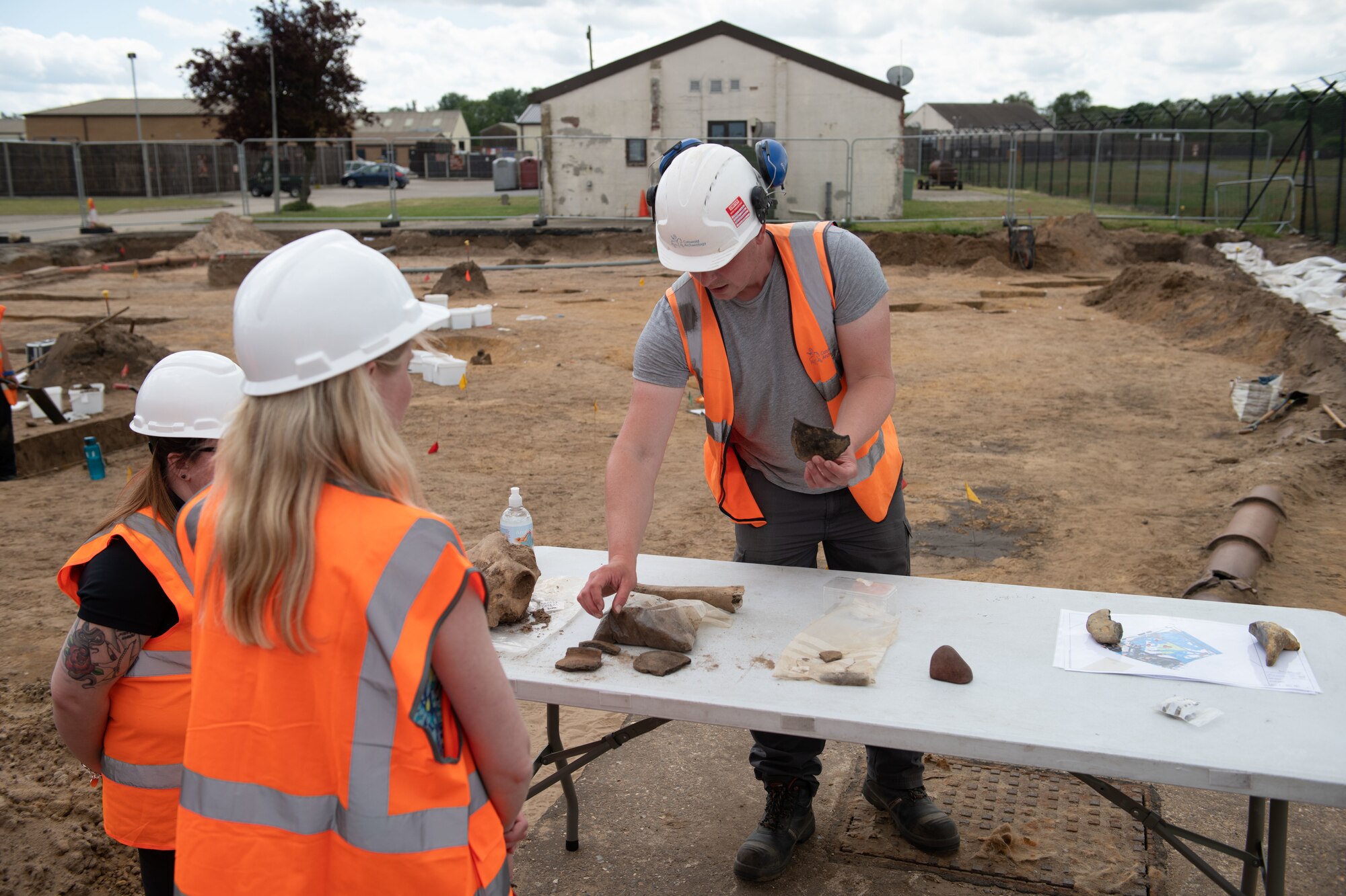 Michael Green, an archaeologist with Cotswold Archaeology, presents artifacts that were uncovered during an archaeological dig on Royal Air Force Lakenheath, England, June 10, 2021. Archaeologists are active team members during construction projects on base because of the abundance of history buried beneath the soil. (U.S. Air Force photo by Airman 1st Class Cedrique Oldaker)