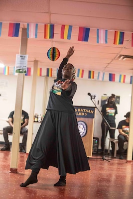 Operations Specialist 2nd Class Lisa King, assigned to the amphibious assault ship USS Bataan (LHD 5), dances during a Juneteenth celebration ceremony in the mess decks.