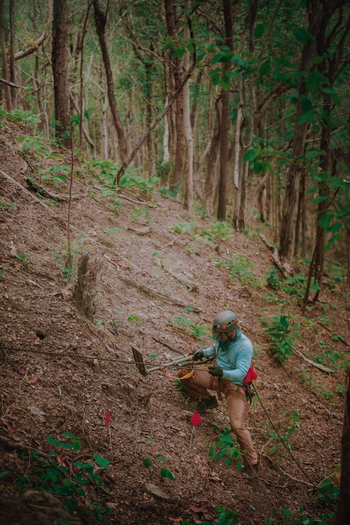 A team member climbs a slope in Kheland Banphot National Park, Thailand during a recent mission. An eight-person team from the Defense POW/MIA Accounting Agency (DPAA) recently completed an investigation mission in the Kingdom of Thailand; the first of its kind in the area in 15 years. The 26-day mission. including an initial quarantine period in Bangkok, centered on DPAA’s efforts to locate the crash sites for two aircraft that crashed near Lampang, Thailand in November 1944 during World War II. The site work began in late April and lasted until May 2. (Courtesy Photo)