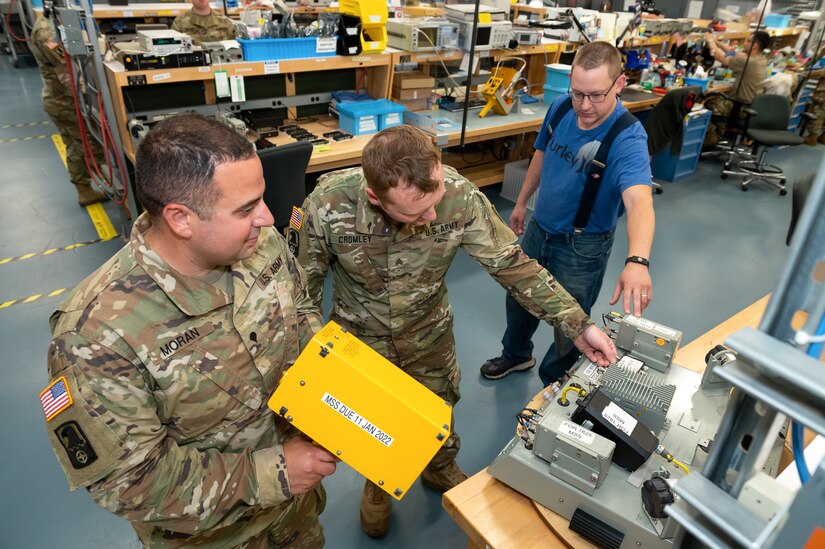 Photo of Electronics Mechanic instructing Soldiers on proper use of electronics equipment during the unit's annual training.