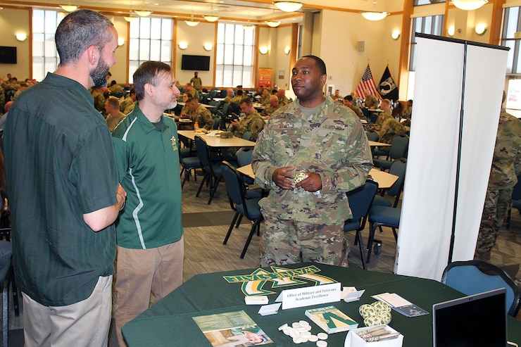Staff Sgt. Greg Glenn, 127th Force Support Squadron, talks with representatives of Wayne State University, about support the university offers for veterans to attend college, here on June 5, 2021