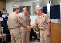 Rear Adm. Curt Copley (center) assumed command of the Office of Naval Intelligence and directorship of the National Maritime Intelligence-Integration Office during a ceremony June 18 at the National Maritime Intelligence Center in Suitland, Md. Deputy Chief of Naval Operations for Information Warfare and Director of Naval Intelligence Vice Adm. Jeffrey Trussler (right), the guest speaker, congratulates Rear Adm. Price (left) for taking the helm for the second time and seamlessly leading the organizations through another leadership transition.