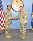 Tech. Sgt. Samara Taylor, a public affairs specialist with the 127th Wing Public Affairs office based here, receives a congratulatory handshake from Chief Master Sgt. Rick Gordon, 127th Wing command chief master sergeant, during a promotion ceremony here on June 5, 2021.