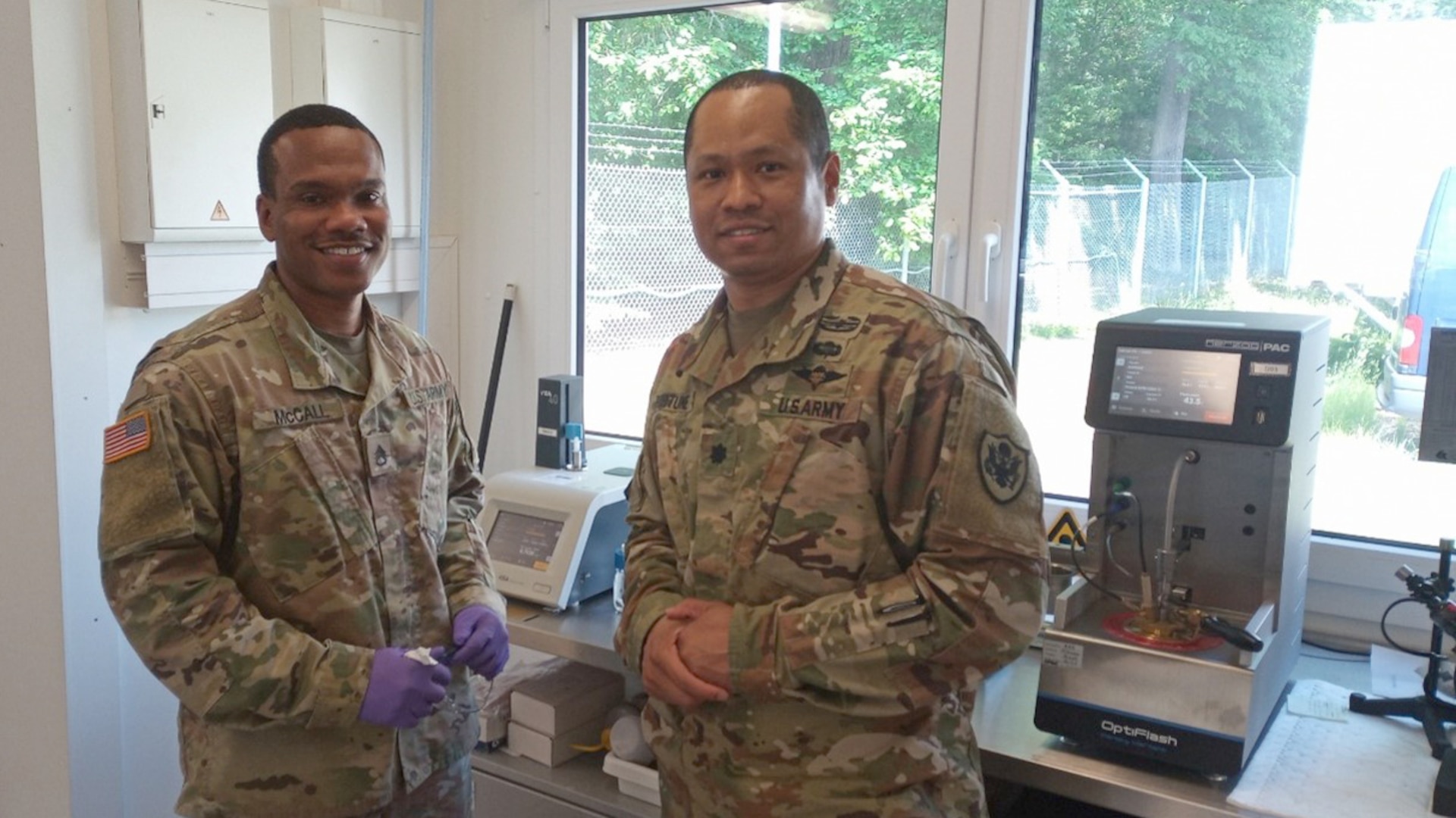 Two military men stand in uniform