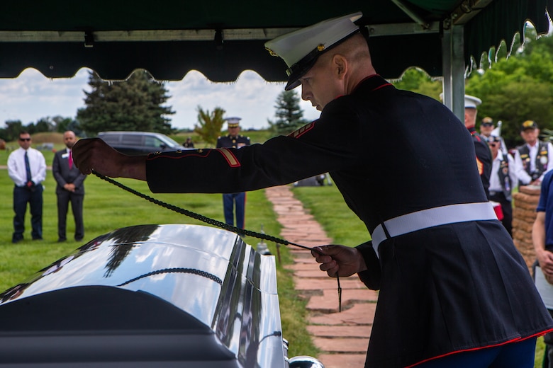 U.S. Marine Corps Sgt. Hunter Haffly, a squad leader with 1st Battalion, 6th Marine Regiment (1/6), 2d Marine Division, places a French Fourragere on the casket of U.S. Marine Corps Sgt. Donald D. Stoddard at Mountain View Memorial Park in Boulder, Colo., June 26, 2021. Stoddard died during the siege of Betio Island in November 1943 during World War II while assigned to 1/6. His remains were recovered in March 2019 by the non-profit organization, History Flight. (U.S. Marine Corps photo by Cpl. Chase W. Drayer)
