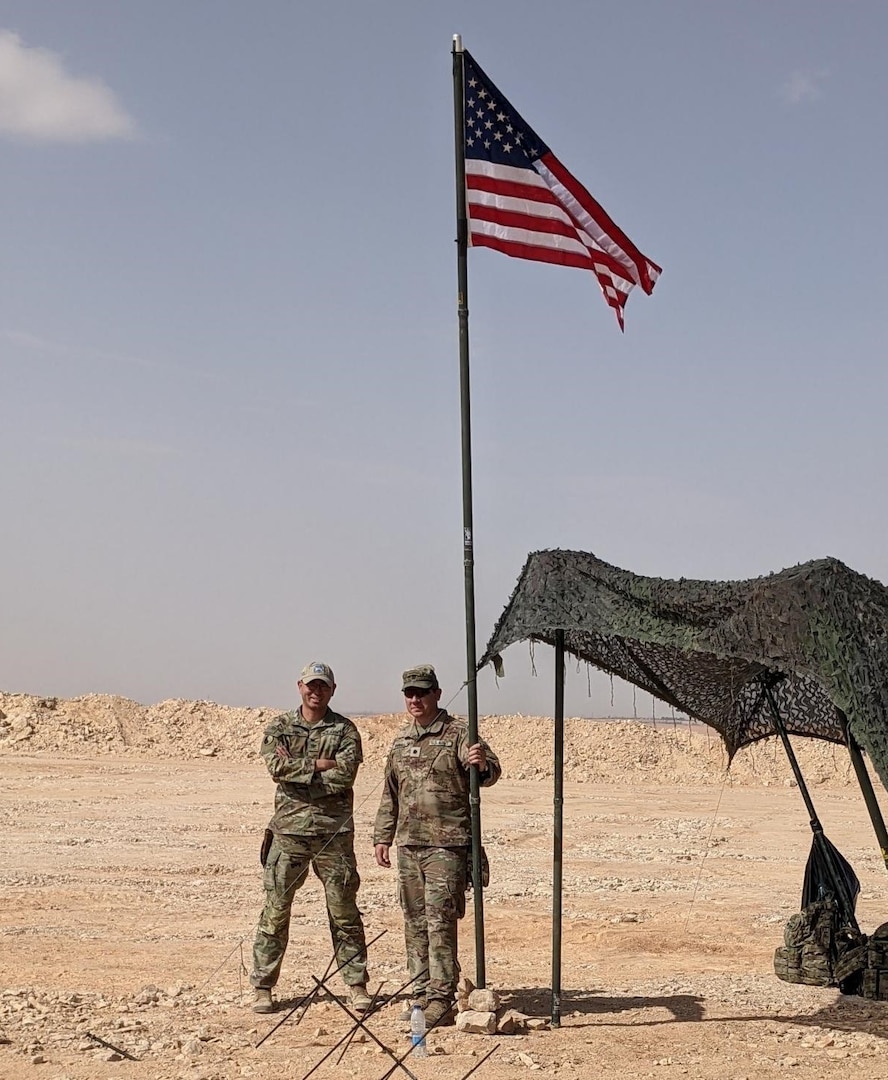Lt Col. Matthew Wignall, battalion commander, stands with Col. Ricky Kue, battalion surgeon, both with 3rd Battalion, 172nd Infantry Regiment (Mountain), Task Force Avalanche, during a site visit in Southwest Asia. The 3-172 IN (MTN) has reached 87 percent of its deployed force being COVID-19 vaccinated. (Photo courtesy of 3-172nd Infantry (Mountain))