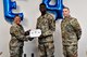 Col. Katrina Stephens, installation commander, and Chief Master Sgt. William Hebb, installation command chief, present Airman 1st Class Jacques Charleceus, 66th Comptroller Squadron financial management specialist, with a promotion to senior Airman, below the zone, at Hanscom Air Force Base, Mass., June 25. Below the Zone is a competitive early promotion that recognizes top performers. (U.S. Air Force photo by Linda LaBonte Britt)