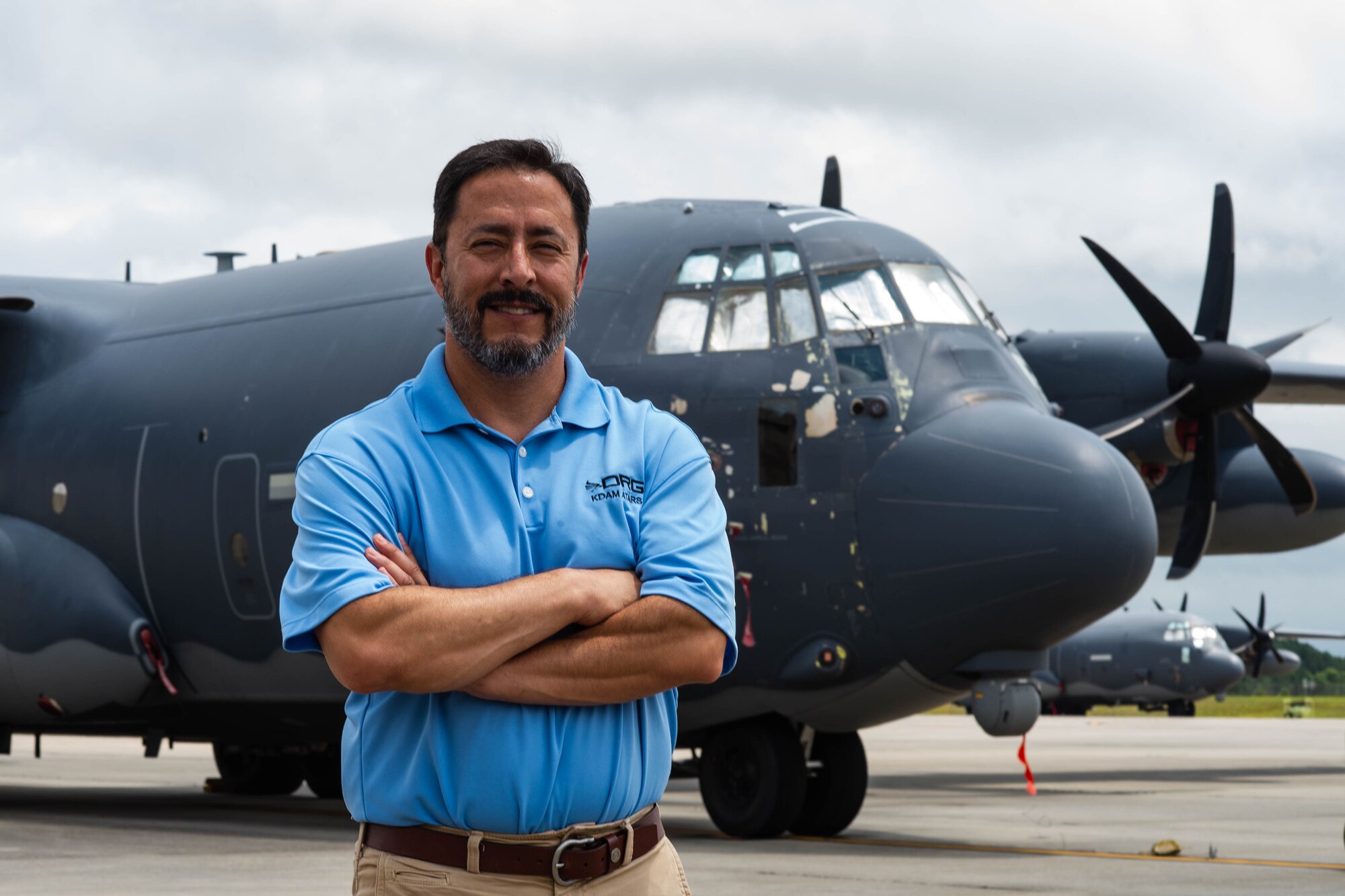 Larry Branch standing in front of a C-130