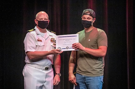 Capt. Jip Mosman, commander, Puget Sound Naval Shipyard & Intermediate Maintenance Facility, poses for a photo with Valor Award winner Isaac Dawson June 28, 2021, during the 2020 Employee of the Year awards ceremony at the historic Admiral Theater in Bremerton, Washington. (PSNS & IMF photo by Scott Hansen)