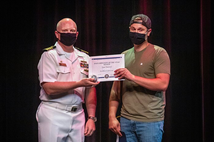 Capt. Jip Mosman, commander, Puget Sound Naval Shipyard & Intermediate Maintenance Facility, poses for a photo with Valor Award winner Isaac Dawson June 28, 2021, during the 2020 Employee of the Year awards ceremony at the historic Admiral Theater in Bremerton, Washington. (PSNS & IMF photo by Scott Hansen)