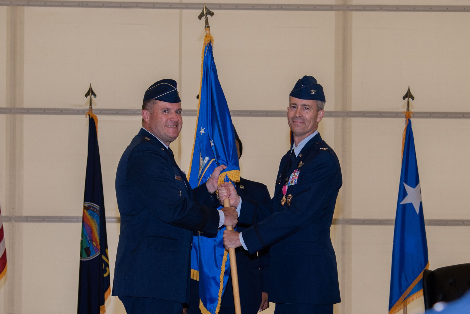Maj. Gen. Kenneth Bibb, 18th Air Force commander, presents the ceremonial guidon to Col. Richard Tanner, 22nd Air Refueling Wing outbound commander, June 28, 2021, at McConnell Air Force Base, Kansas. This act marks the official end of Tanner’s tenure as commander of the 22nd ARW. (U.S. Air Force Photo by Airman 1st Class Zachary Willis)