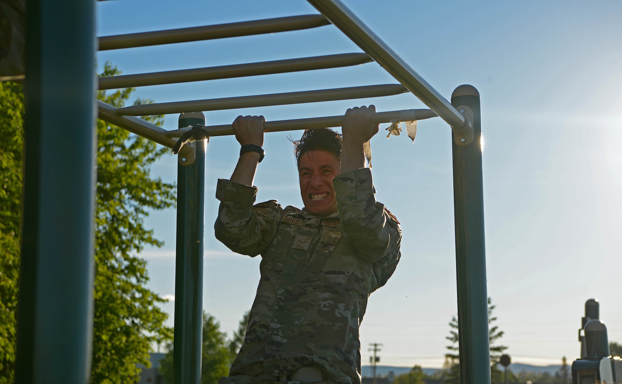 U.S. Air Force Airman 1st Class Michael Flores, a 354th Security Forces Squadron installation entry controller, does a pull-up during a special weapons and tactics (SWAT) physical training test June 23, 2021 on Eielson Air Force Base, Alaska. A physical training test challenged defenders to meet the demanding standard of SWAT training.(U.S. Air Force photo by Senior Airman Beaux Hebert)