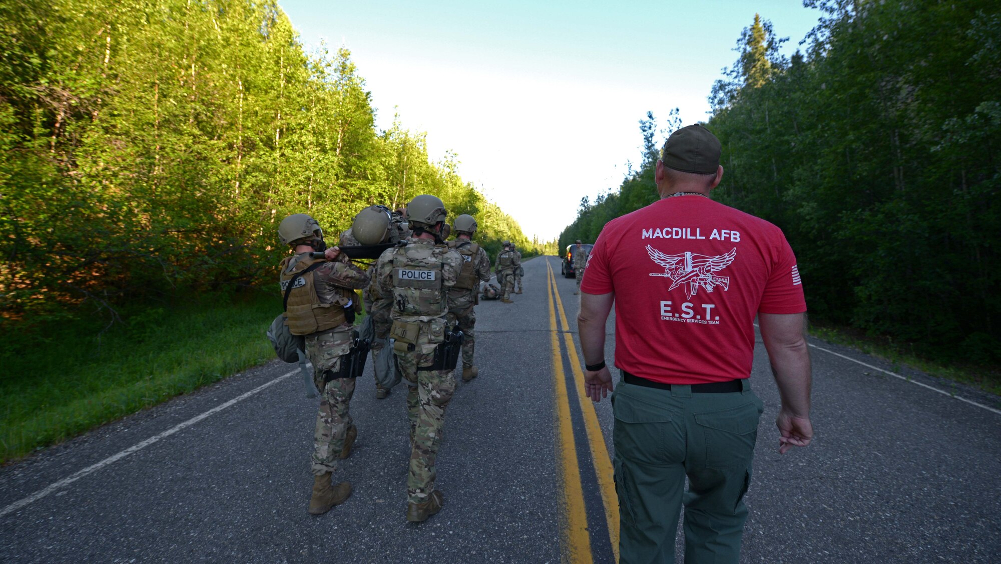 A U.S. Air Force Emergency Services Team instructor from MacDill Air Force Base, Florida, watches Airmen from the 354th Security Forces Squadron (SFS) carry a simulated casualty during special weapons and tactics (SWAT) training June 23, 2021 on Eielson Air Force Base, Alaska. The instructors came here to train defenders from the 354th SFS to be members of a SWAT team.  (U.S. Air Force photo by Senior Airman Beaux Hebert)