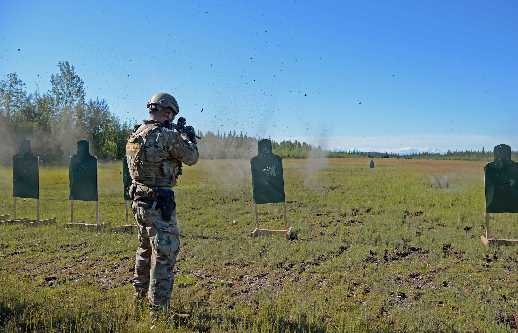 A U.S. Air Force Airman from the 354th Security Forces Squadron fires his weapon at a target during special weapons and tactics training June 23, 2021 on Eielson Air Force Base, Alaska. Defenders trained with handguns and rifles to familiarize themselves with different types of weapon platforms to become more adaptable in the event of an emergency. (U.S. Air Force photo by Senior Airman Beaux Hebert)