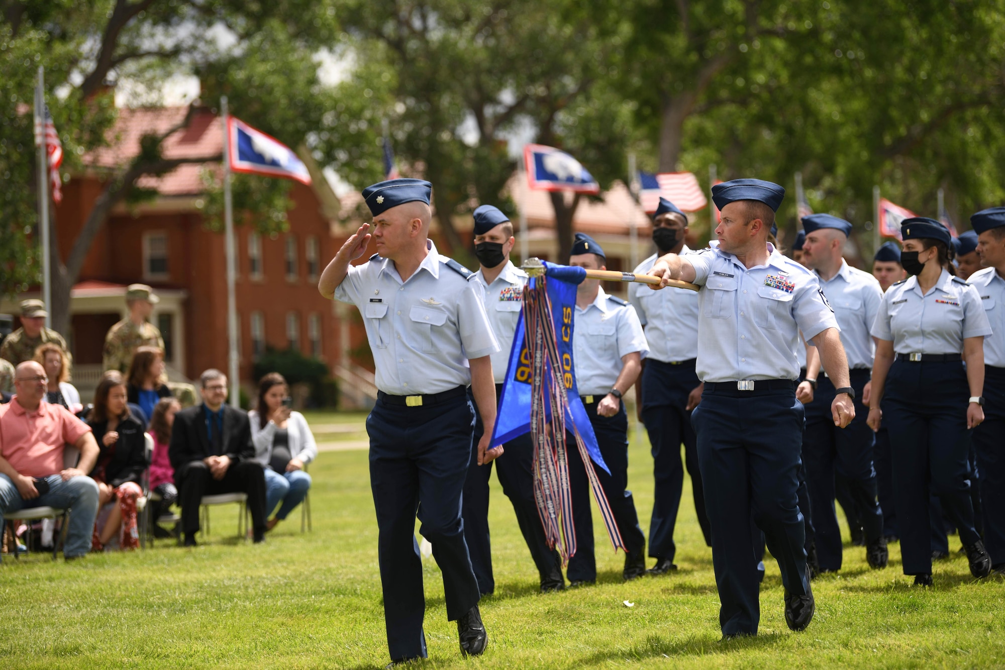 Airman from the 90th Communications Squadron render a salute to their new wing commander Col. Catherine Barrington, 90th Missile Wing commander, during the 90 MW change of command ceremony June 28, 2021, F.E. Warren Air Force Base, Wyoming. The ceremony signified the transition of command from Col. Peter Bonetti to Col. Catherine Barrington. (U.S. Air Force photo by Airman 1st Class Darius Frazier)