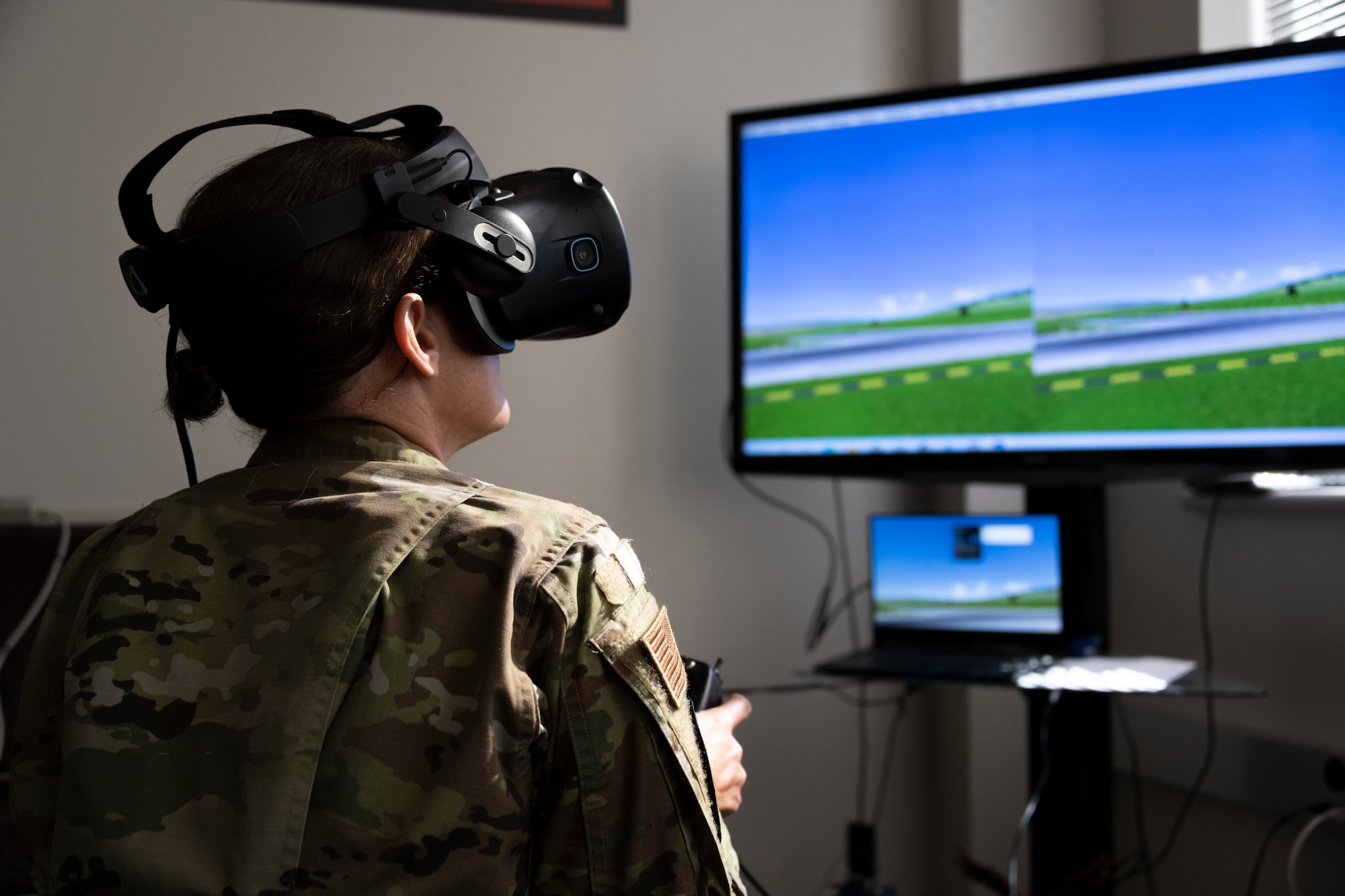 An airman uses a virtual reality drone